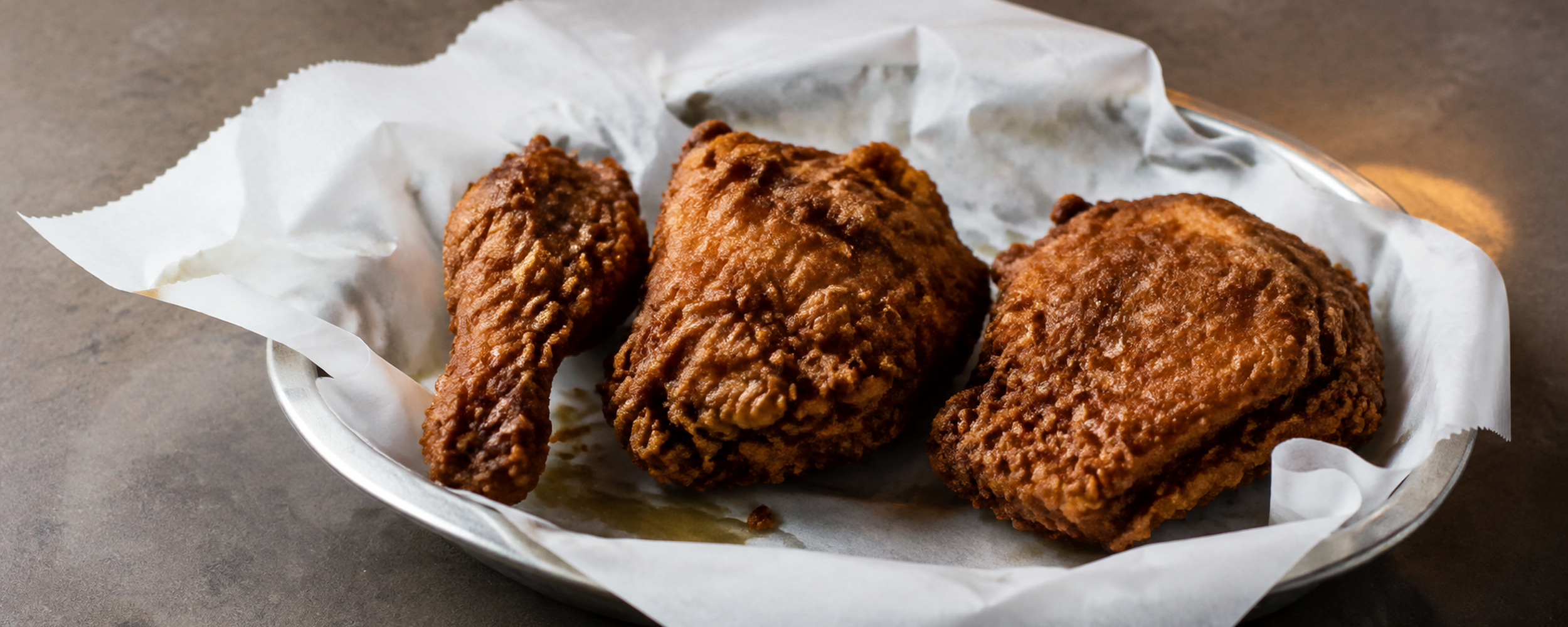Crisp craggy fried chicken on diner paper
